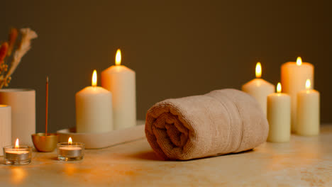 Still-Life-Of-Lit-Candles-With-Dried-Grasses-Incense-Stick-And-Soft-Towels-As-Part-Of-Relaxing-Spa-Day-Decor-3